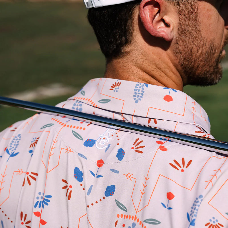 Raised By Coyotes- Wildflowers Golf Polo